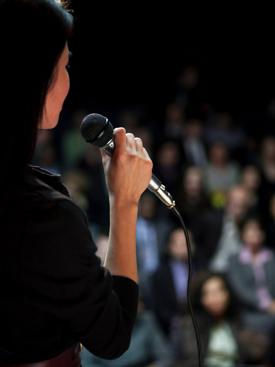 Business woman speaking to crowd